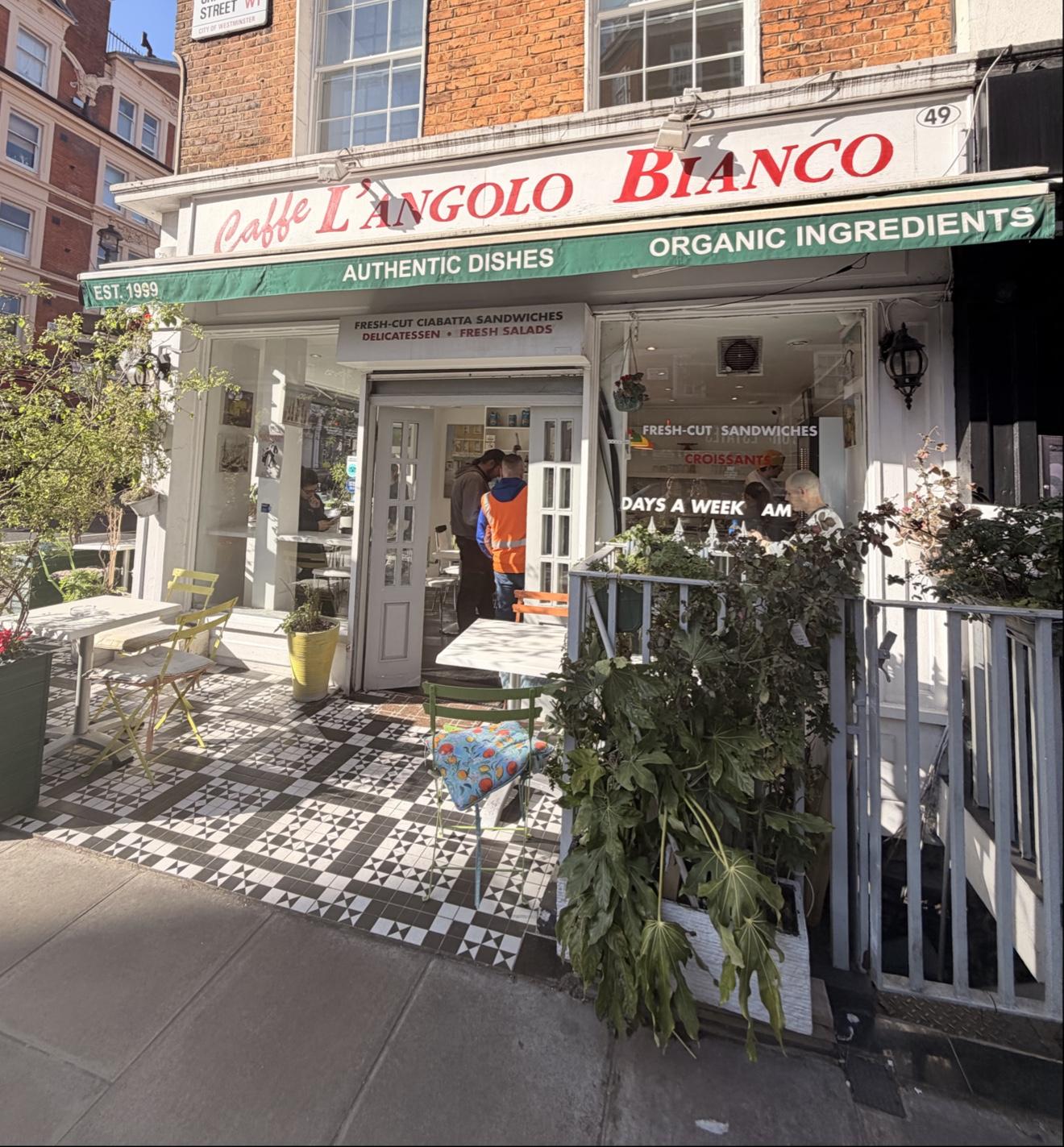 The Crawford Street facade — Caffè L'Angolo Bianco sign, checkered pavement and the open door